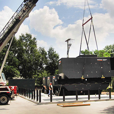 Cranes lifting Generac Industrial Power generators on location.