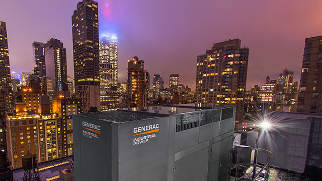 Generac Industrial Generator in city lights at night.