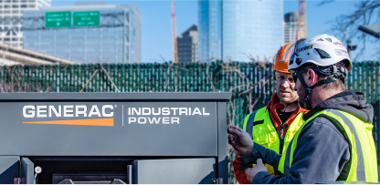 Image of workers standing by a Generac Generator