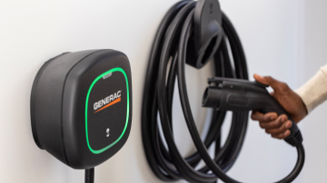 Person lifting Generac EV Charger plug from mount