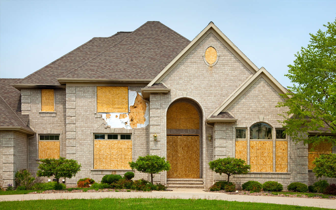 house with boarded up windows and doors