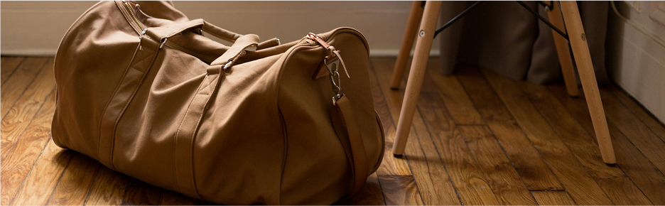 A brown emergency go-bag containing essential items to pack when evacuating before a hurricane
